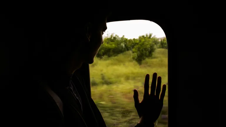 person looking out of train window