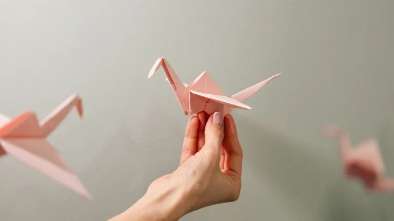 Eine Frau hält einen Papierkranich