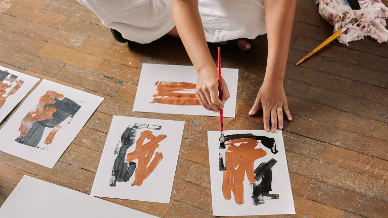 artist painting on floor
