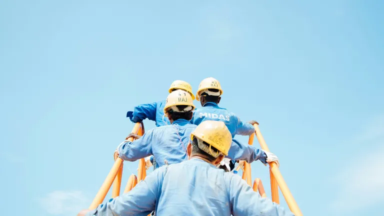 Men with helmet walking up the stairs.