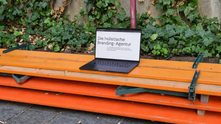 Macbook with Sergeant website on wooden benches