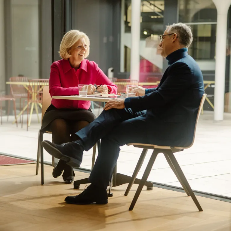 Two co-workers having a break and drinking water