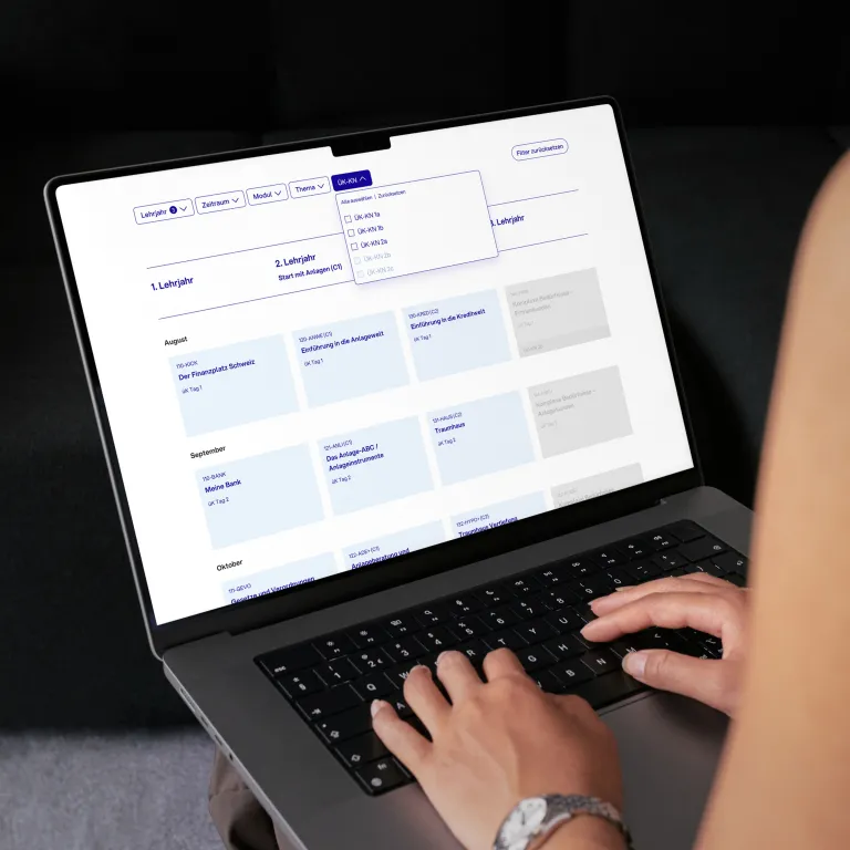 hand typing on keyboard of laptop, on screen the CYP website