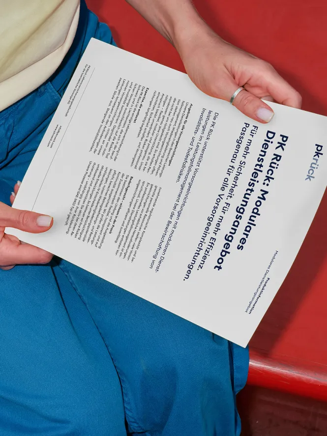 Hands holding PK Rück fact sheet