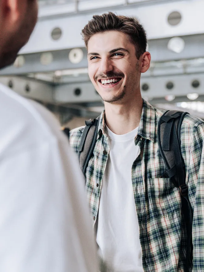 man laughing with person in front of him