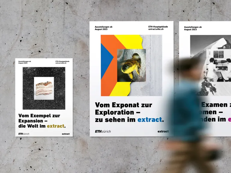 Person walking by a wall full of ETH Extract posters