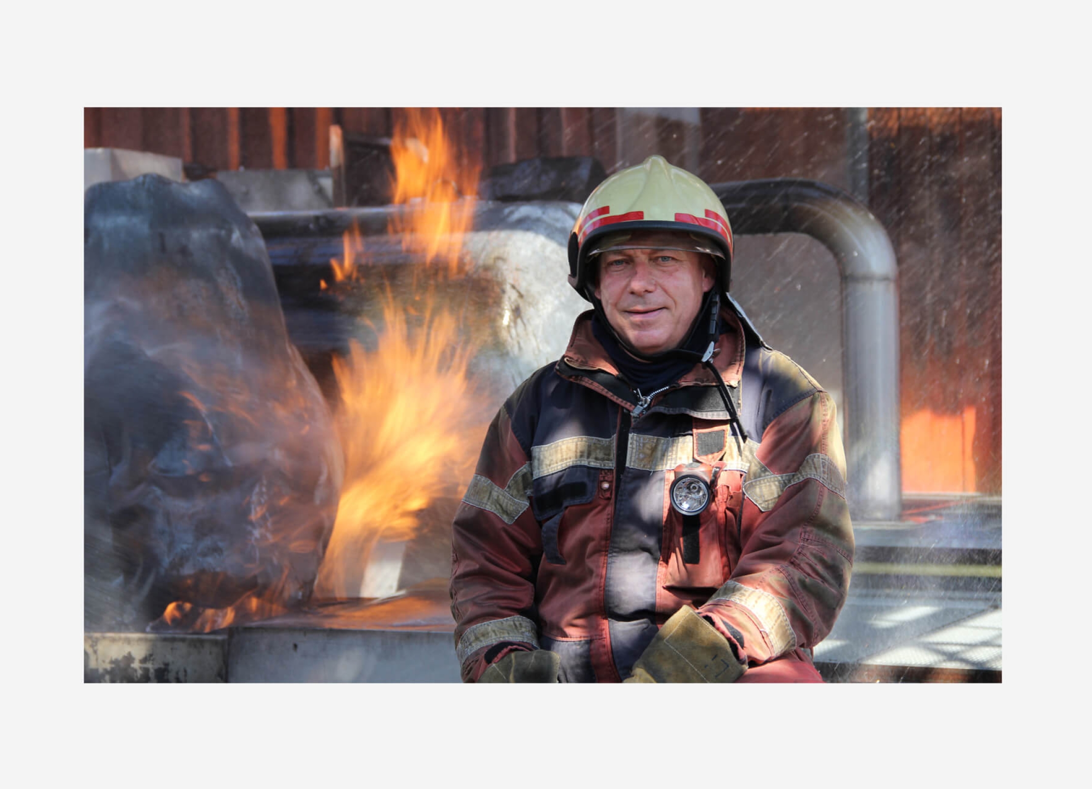 a fireman with fire in the background