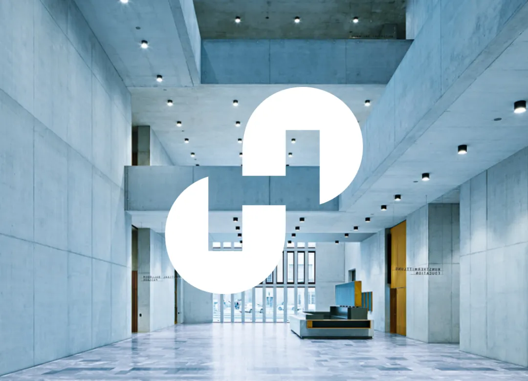 white Holcim logo on the background of a modern building hall