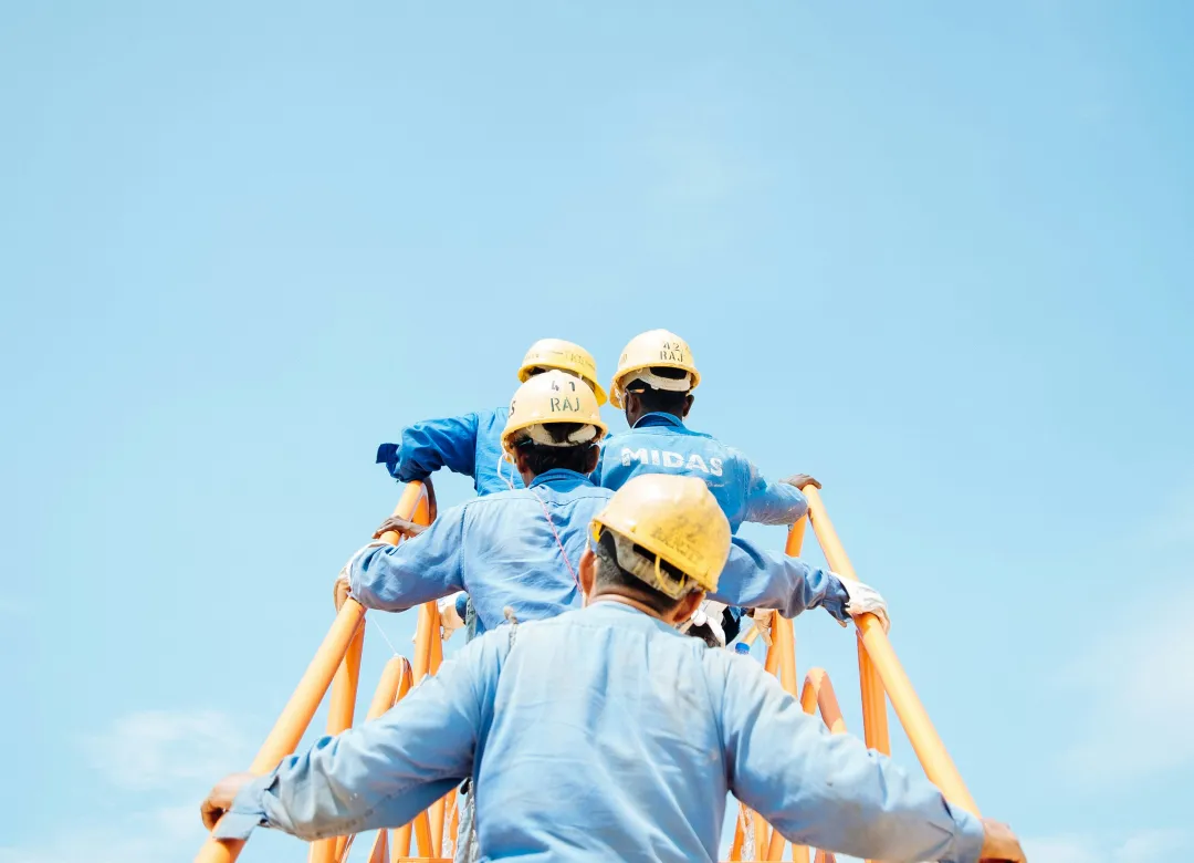 construction workers ascending stairs